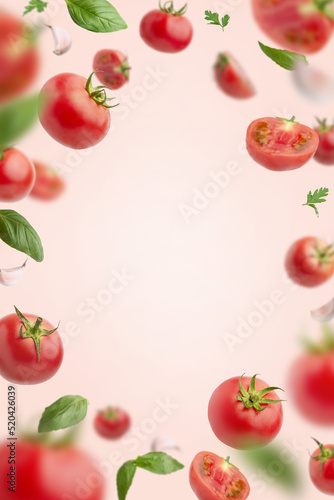 Fototapeta Naklejka Na Ścianę i Meble -  flying tomatoes with basic = onion and garlic. Flying ingredients for tomato sauce