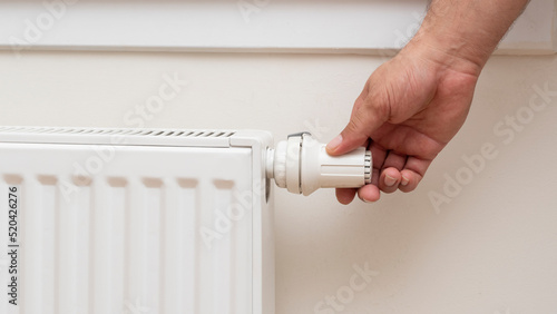 Wallpaper Mural Man's hand adjusting the temperature of a radiator. front view Torontodigital.ca