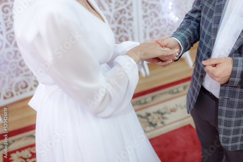 Newlyweds exchange wedding rings. The bride rings the groom. Wedding ceremony. The concept of a strong family. The concept of a marriage contract.