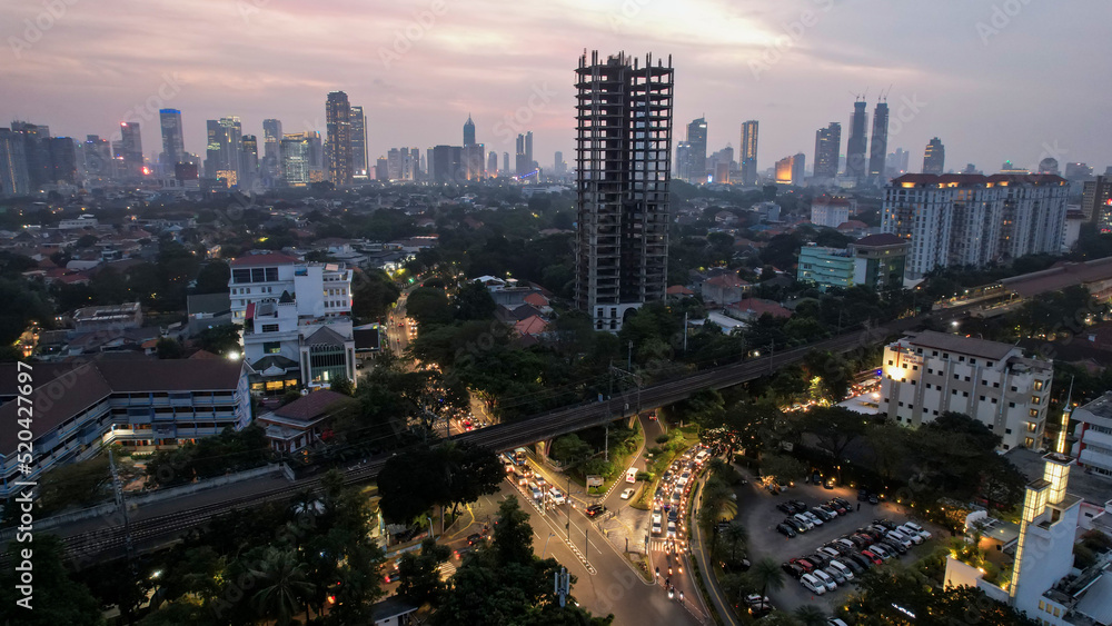 Obraz premium Aerial view of office buildings in Jakarta central business district and noise cloud when sunset. 