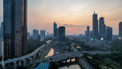 Aerial view of office buildings in Jakarta central business district and noise cloud when sunset.