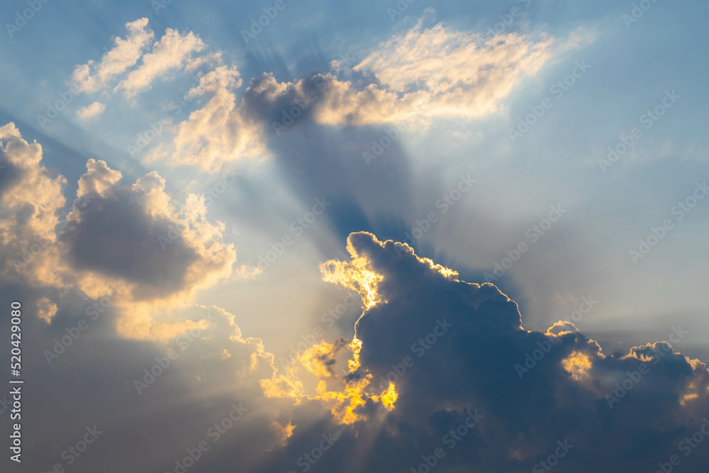 Ray of sun or sunbeam shining through the cloudy clouds in the sky before raining, Cumulus are clouds which have flat bases and are often described as puffy, Horizon nature background.