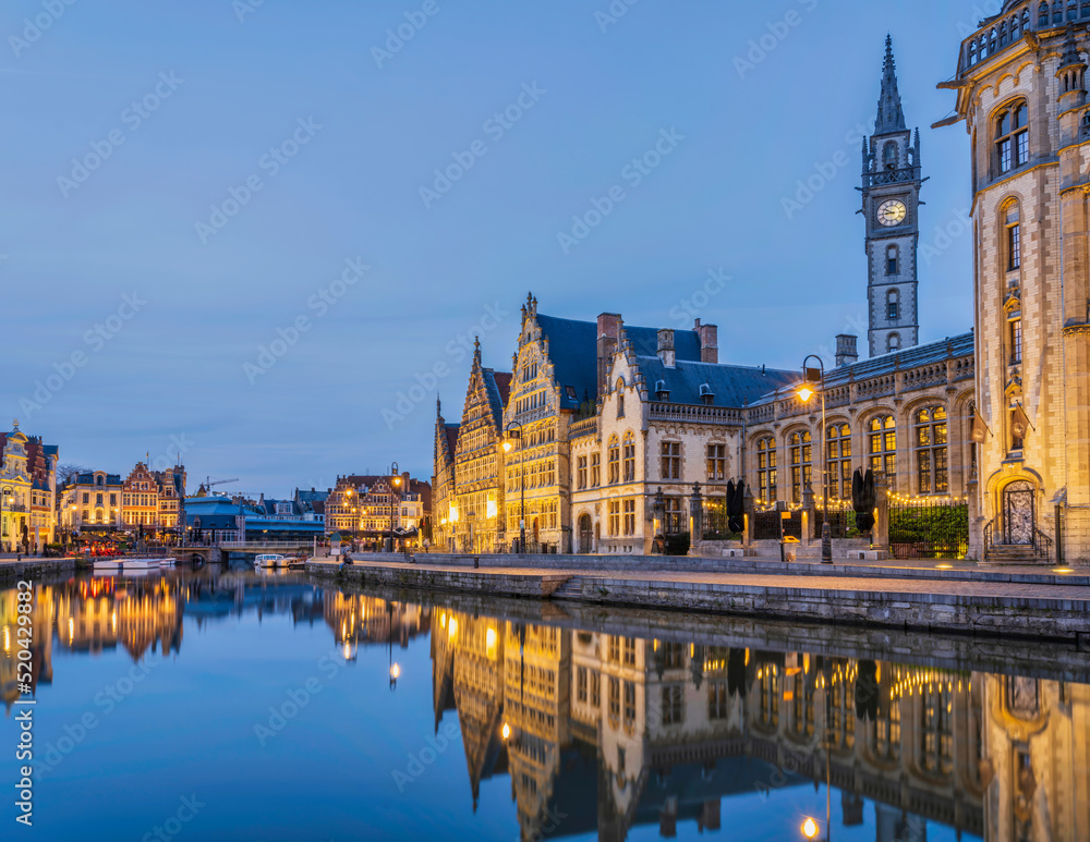 Fototapeta premium Historic medieval building at dusk on Leie river in Ghent, Belgium