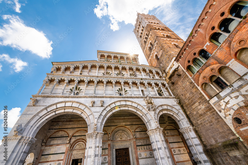 The three arches and tower of the Saint Martin Cathedral in the historic walled town of Lucca, Italy.