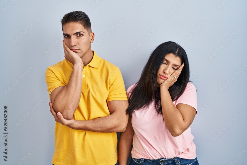 Young couple standing over isolated background thinking looking tired and bored with depression problems with crossed arms. Young couple standing over isolated background thinking looking tired and bored with depression problems with crossed arms.