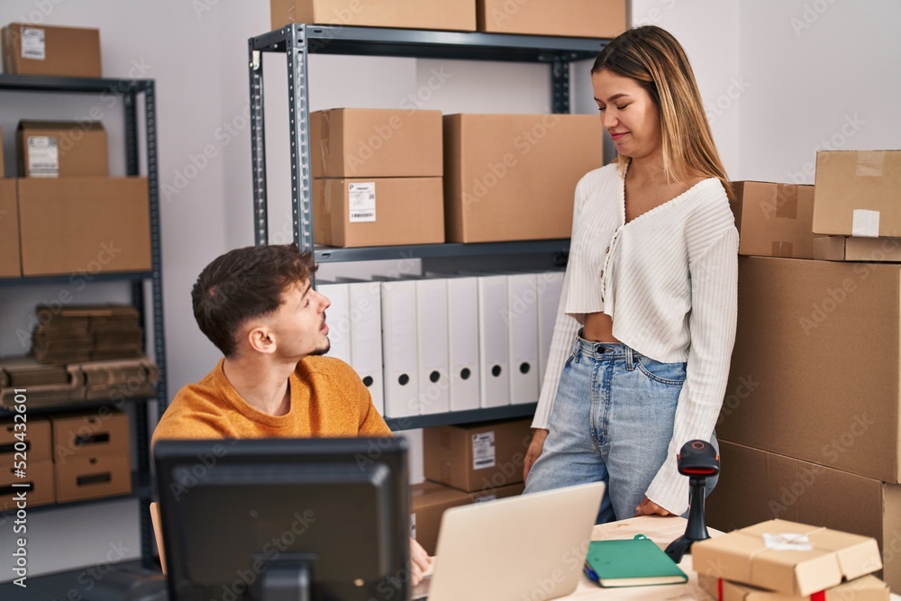 Young man and woman ecommerce business workers working at office Young man and woman ecommerce business workers working at office