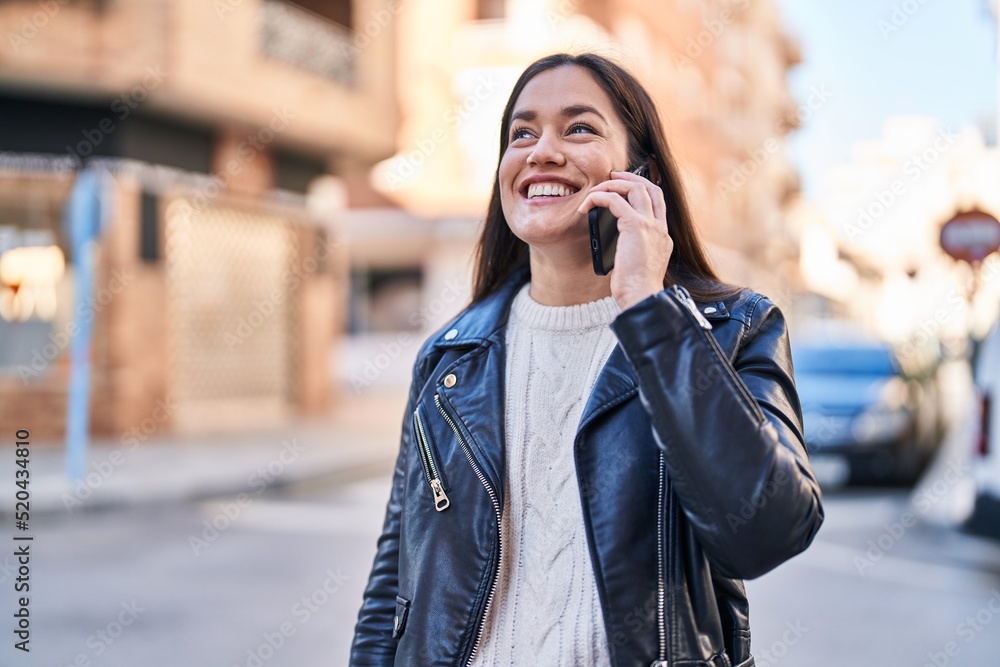 Young woman smiling confident talking on the smartphone at street Young woman smiling confident talking on the smartphone at street