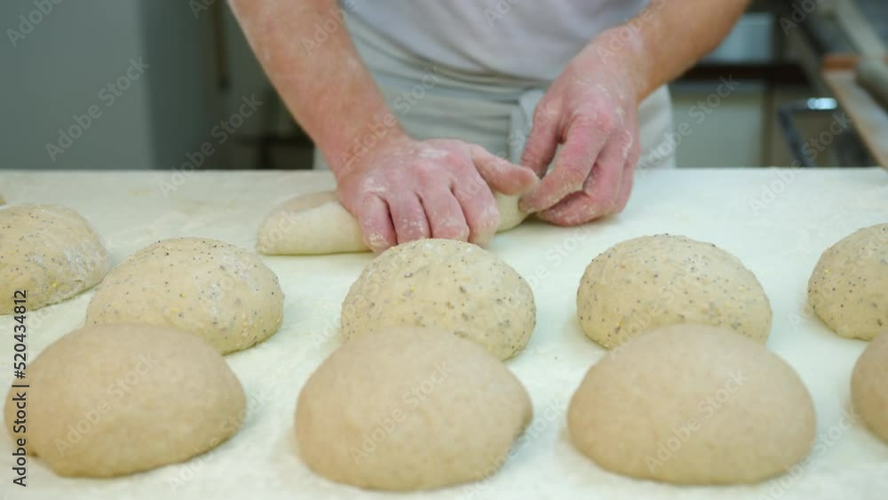 Kneading Dough. Baker preparing the dough for bread. Manufacture of bakery products. The baker is making dough products. Kneading Dough. Baker preparing the dough for bread. Manufacture of bakery products. The baker is making dough products.