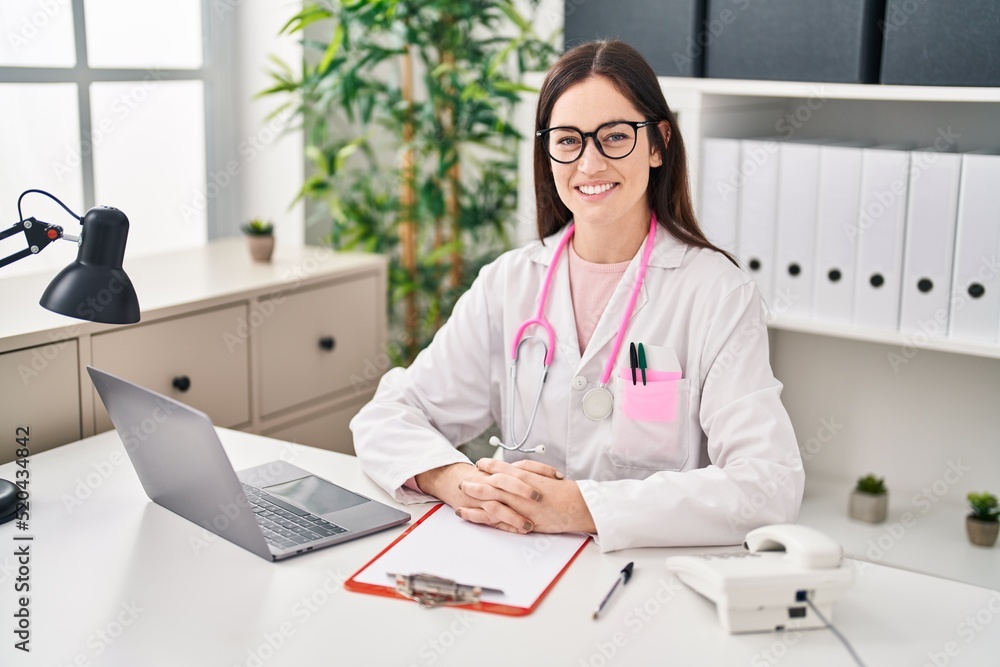 Young woman wearing doctor uniform working at clinic Young woman wearing doctor uniform working at clinic