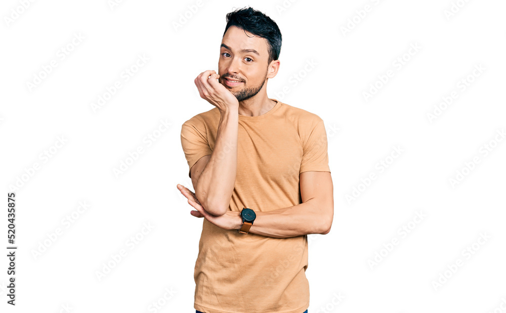 Hispanic man with beard wearing casual t shirt with hand on chin thinking about question, pensive expression. smiling and thoughtful face. doubt concept. Hispanic man with beard wearing casual t shirt with hand on chin thinking about question, pensive expression. smiling and thoughtful face. doubt concept.