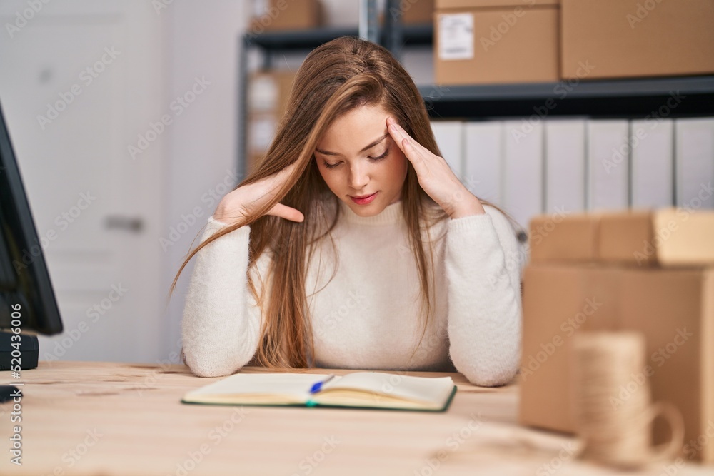 Young blonde woman ecommerce business stressed working at office Young blonde woman ecommerce business stressed working at office