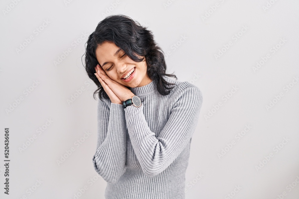 Hispanic woman with dark hair standing over isolated background sleeping tired dreaming and posing with hands together while smiling with closed eyes. Hispanic woman with dark hair standing over isolated background sleeping tired dreaming and posing with hands together while smiling with closed eyes.
