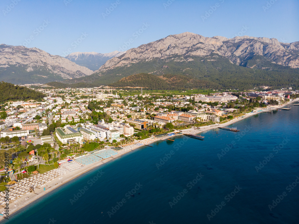 Aerial photo of Kemer, seaside town in Turkey on Mediterranean coast, with view of Taurus Mountains in background.