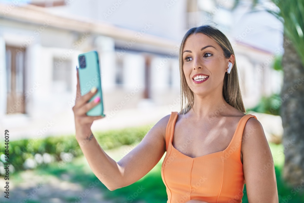 Young beautiful hispanic woman smiling confident having video call at park