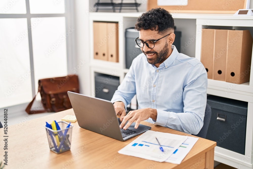 Young hispanic man business worker using laptop working at office Young hispanic man business worker using laptop working at office