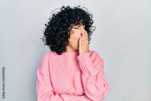 Young middle east woman wearing casual clothes bored yawning tired covering mouth with hand. restless and sleepiness. © Krakenimages.com