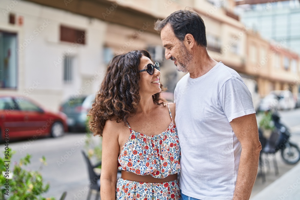 Man and woman couple smiling confident standing together at street Man and woman couple smiling confident standing together at street