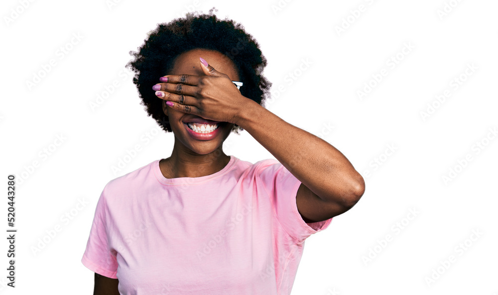 African american woman with afro hair wearing casual clothes and glasses smiling and laughing with hand on face covering eyes for surprise. blind concept. African american woman with afro hair wearing casual clothes and glasses smiling and laughing with hand on face covering eyes for surprise. blind concept.