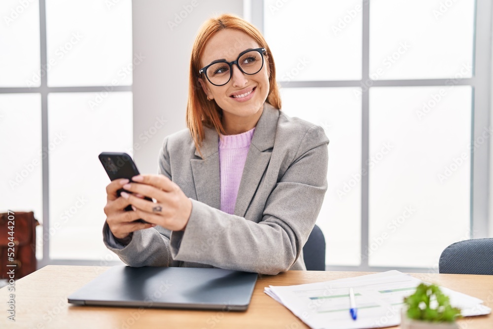 Young caucasian woman business worker using smartphone working at office Young caucasian woman business worker using smartphone working at office
