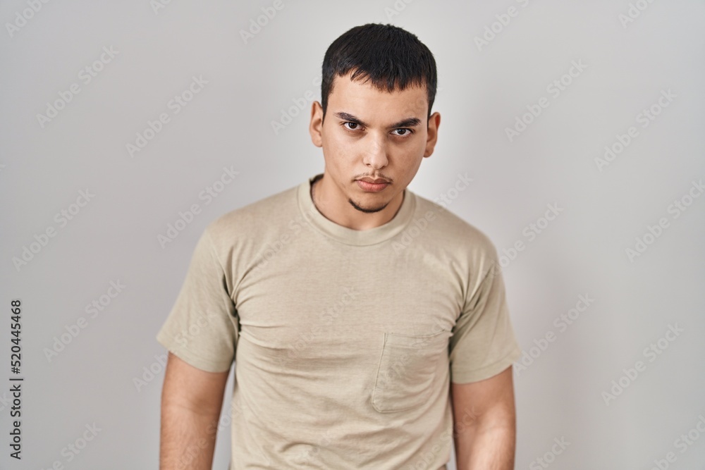 Young arab man wearing casual t shirt skeptic and nervous, frowning upset because of problem. negative person. Young arab man wearing casual t shirt skeptic and nervous, frowning upset because of problem. negative person.
