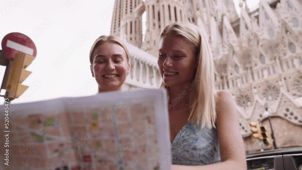 Happy friends enjoying her trip in Barcelona holding a map. Cinematic 4K Happy friends enjoying her trip in Barcelona holding a map. Cinematic 4K