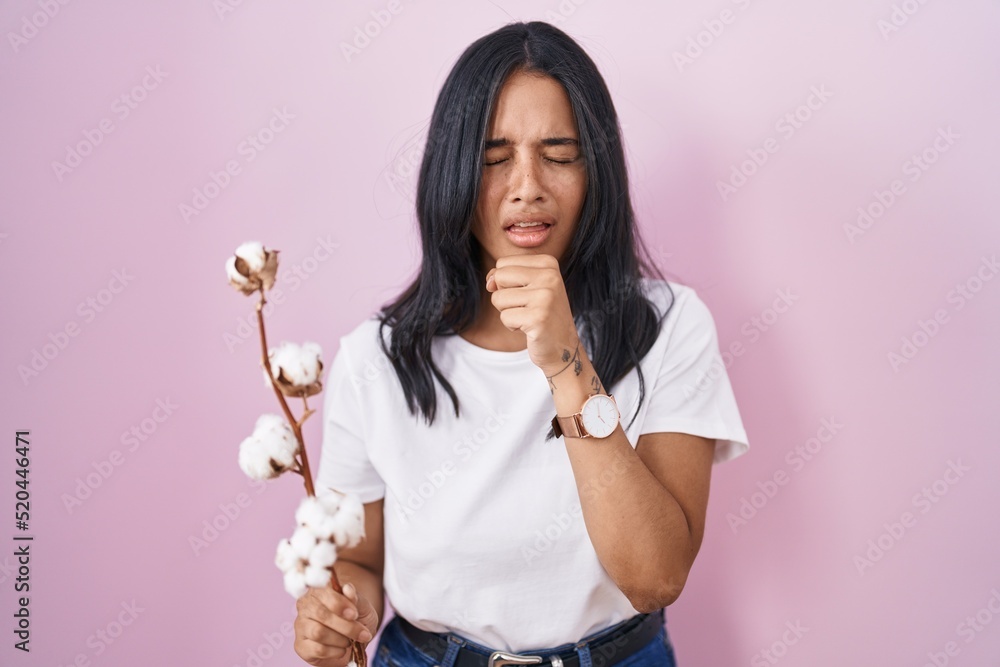 Brunette woman standing over pink background feeling unwell and coughing as symptom for cold or bronchitis. health care concept. Brunette woman standing over pink background feeling unwell and coughing as symptom for cold or bronchitis. health care concept.