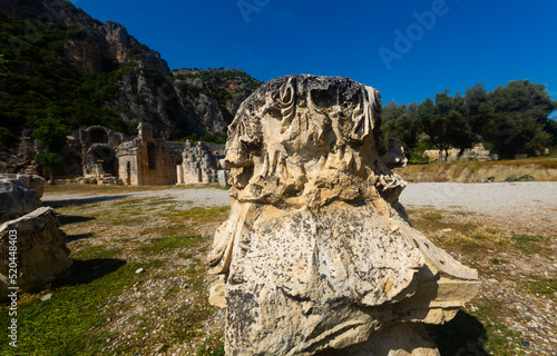View of fragments of ancient sculptures, reliefs and architectural elements outdoors on sunny summer day on archaeological site of Myra in Demre, Turkey photo