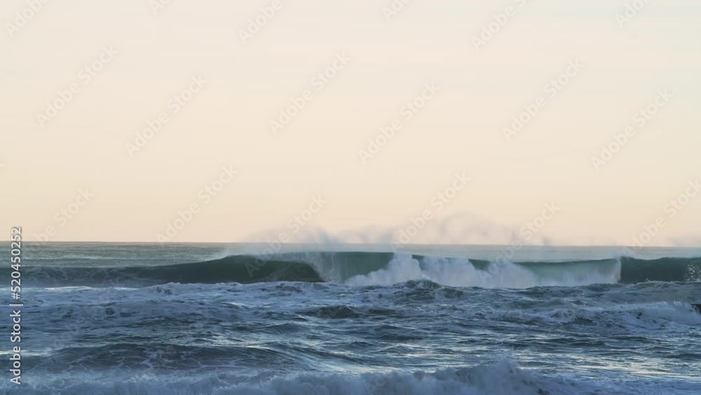Big Waves Breaking Ocean Seascape Background with Copy Space in Orange Sunset Light, Sea Crashing Below Horizon from Low Angle Big Waves Breaking Ocean Seascape Background with Copy Space in Orange Sunset Light, Sea Crashing Below Horizon from Low Angle