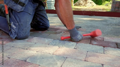 Professional paver pile up red pavestones. Handheld shot. photo