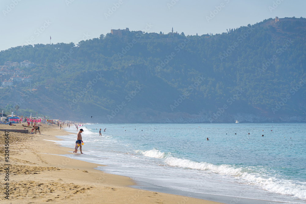 Tourists rest on the beach, Mediterranean sea, Alanya, Turkey Tourists rest on the beach, Mediterranean sea, Alanya, Turkey