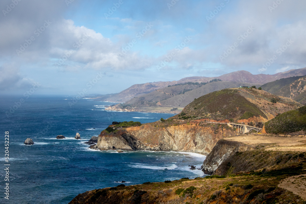 Big Sur Coastline with Rocky Cliffs, Blue Sky and Puffy White Clouds