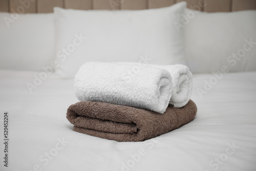 Soft clean terry towels on white bed © New Africa