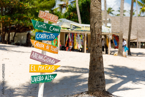Dominican Republic Bavaro Punta cana provinces La Altagracia. Wooden pillar with signposts directions photo