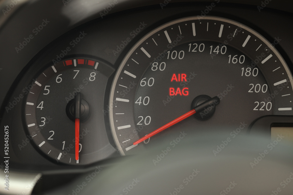 Closeup view of dashboard with warning icon check airbag system in car