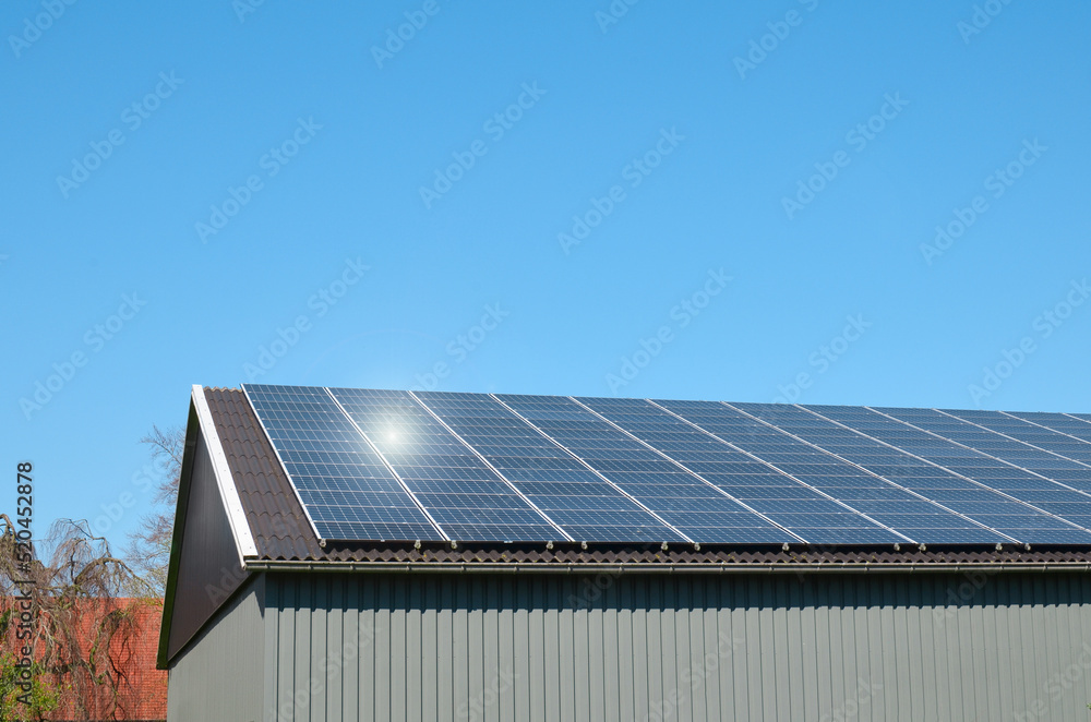 Building with installed solar panels on roof. Alternative energy source Building with installed solar panels on roof. Alternative energy source