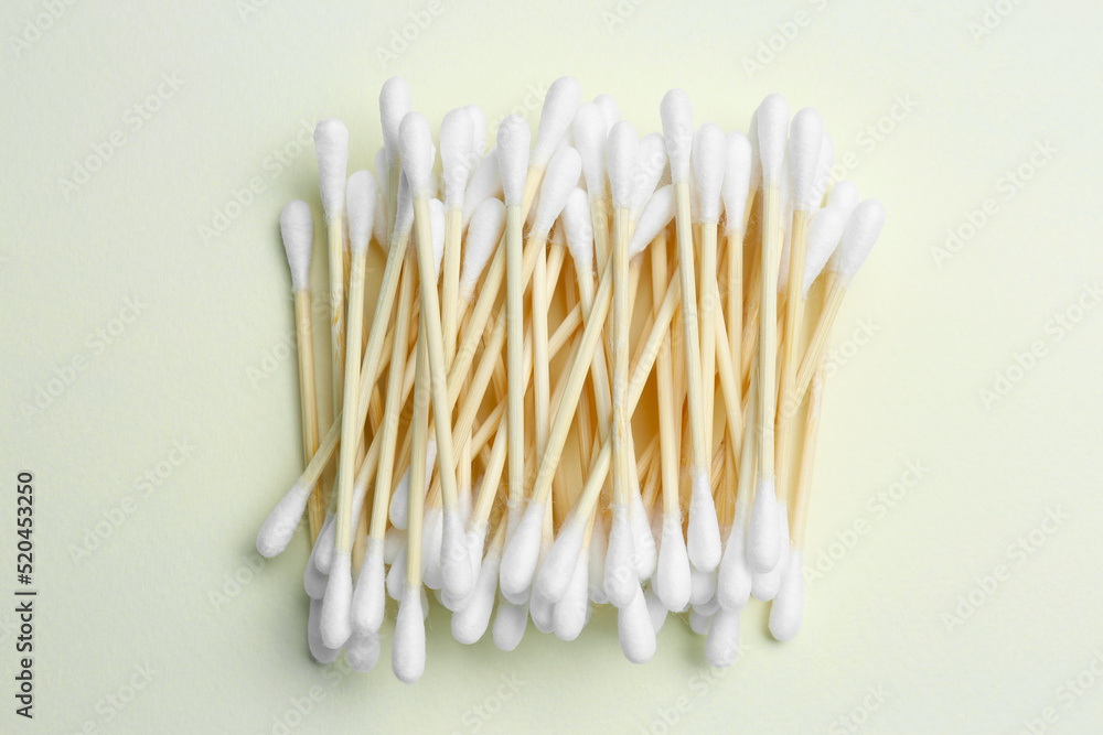 Heap of cotton buds on beige background, top view Heap of cotton buds on beige background, top view