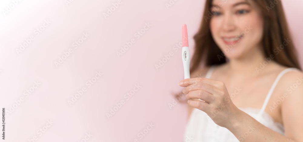 happy pregnant woman holding and showing positive pregnancy test happy pregnant woman holding and showing positive pregnancy test