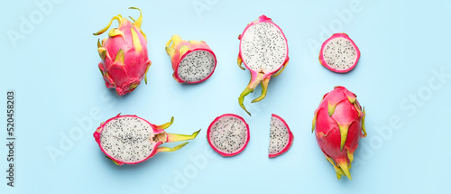 Tasty dragon fruit on light blue background photo