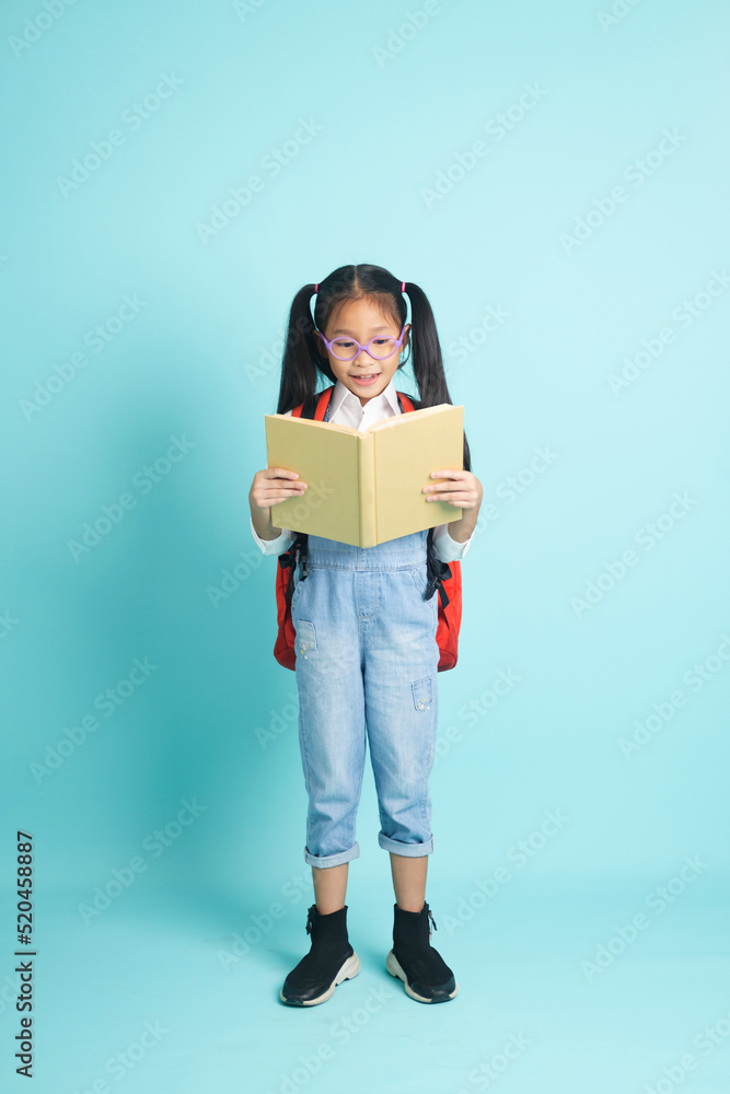 Close-up kid students girl smiling holding book, going to school. Close-up kid students girl smiling holding book, going to school.