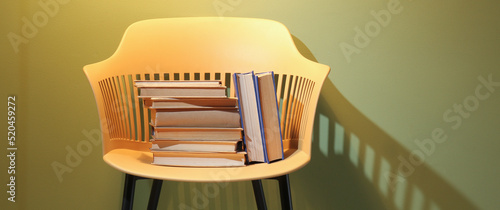 Chair with books near color...