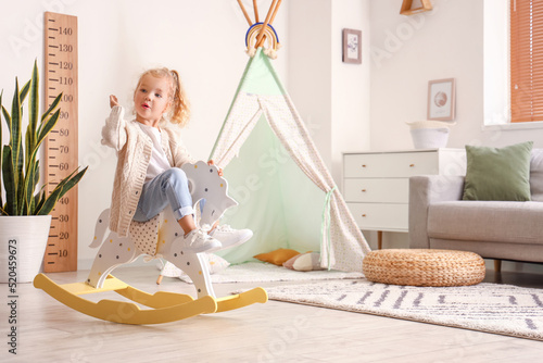 Cute little girl playing wi...