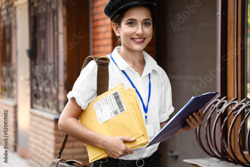 Young postwoman with letter...