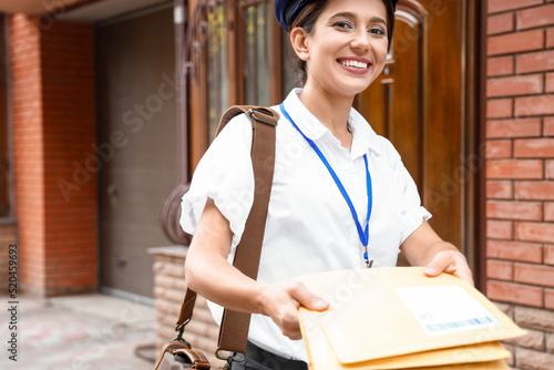 Young postwoman with letter...