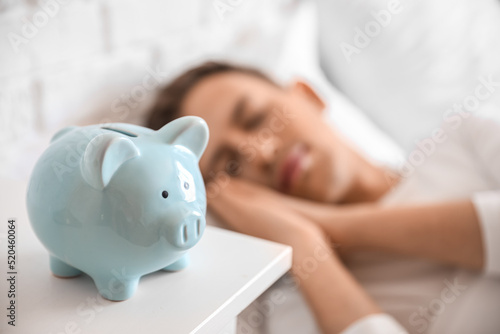 Piggy bank on table of slee...