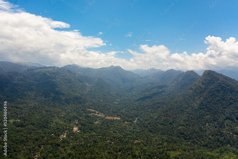 Mountains covered rainforest, trees and blue sky with clouds. Sri Lanka. Mountains covered rainforest, trees and blue sky with clouds. Sri Lanka.