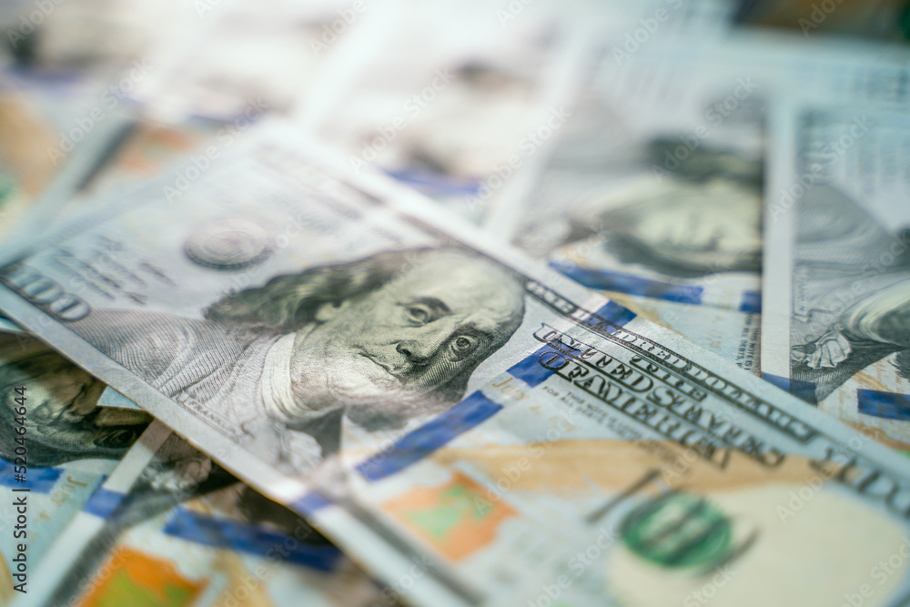 Portrait of Benjamin Franklin on a dollar banknote. A close-up of a hundred dollar bill stands on a pile of money. Portrait of Benjamin Franklin on a dollar banknote. A close-up of a hundred dollar bill stands on a pile of money.