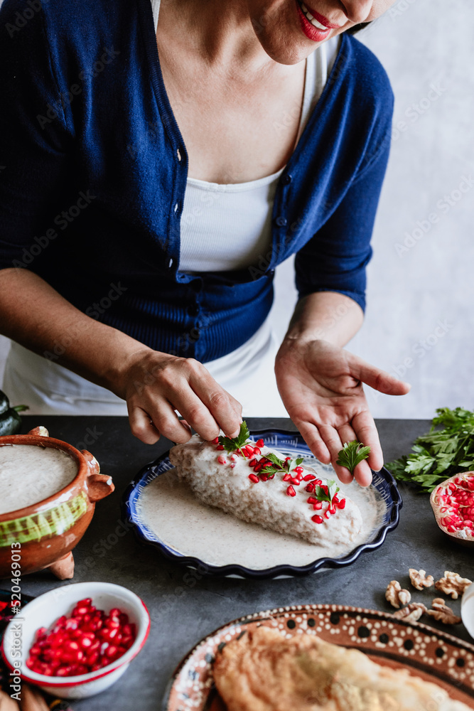 mexican woman hands preparing and cooking chiles en nogada recipe with Poblano chili and ingredients, traditional dish in Puebla Mexico	