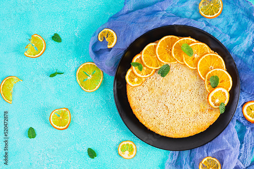 Delicious homemade orange tart on blue background