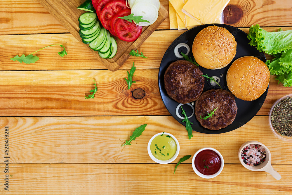 Ingredients for burger on wooden background. Top view Ingredients for burger on wooden background. Top view