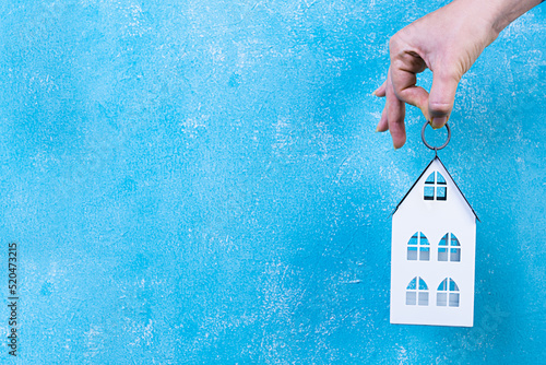Home sweet home. Home symbol in hand on blue background.